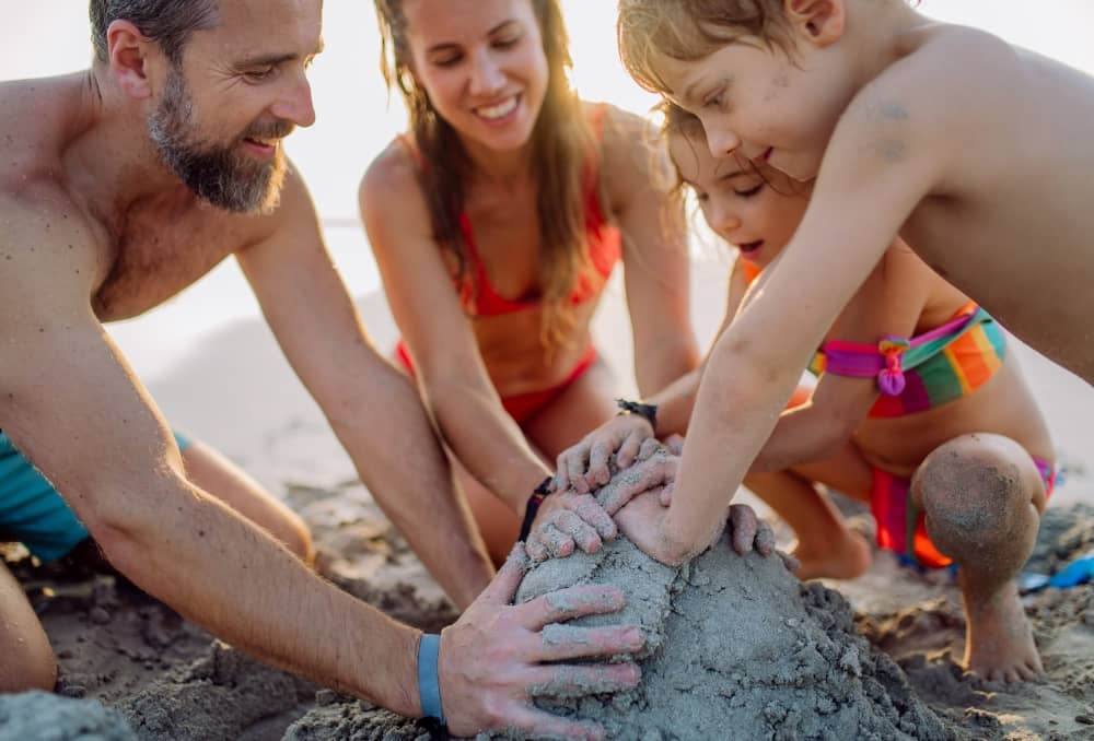 Manipulating sand to create shapes and intricate details helps improve fine motor skills in children.