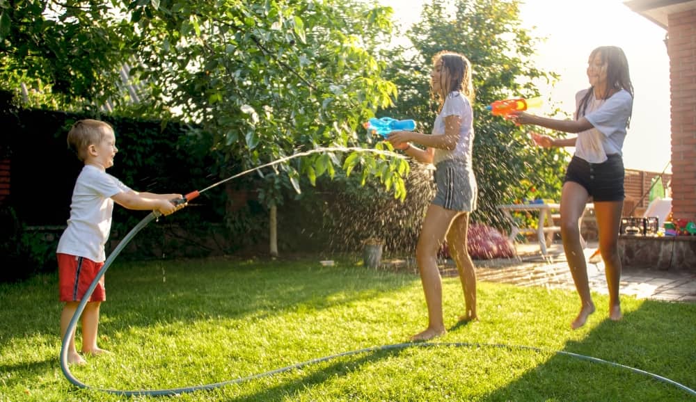 Nature play ideas don't have to be complex. A water fight is great for kids of all ages.
