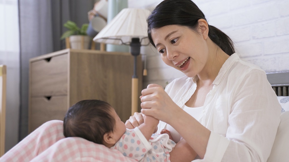 Mum singing nursery rhymes to her baby
